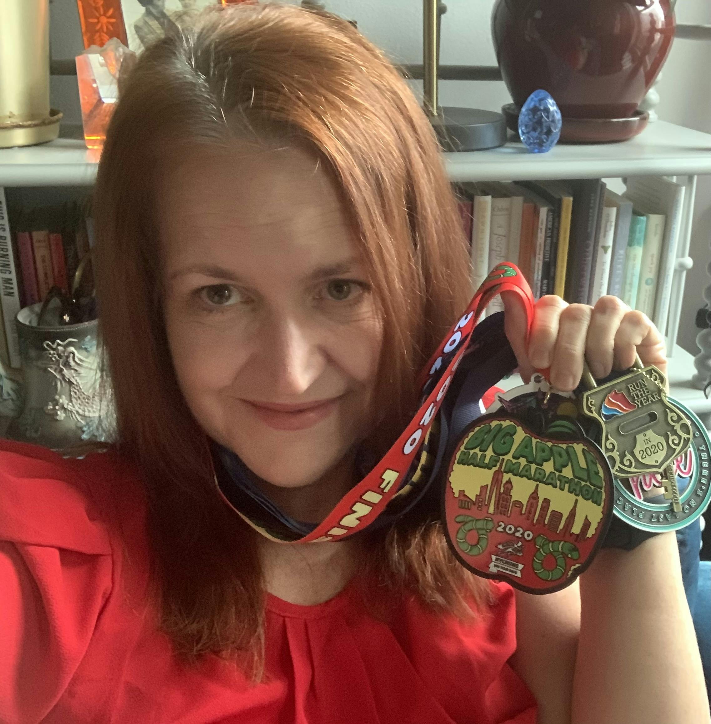 Catherine Burns holding race medals