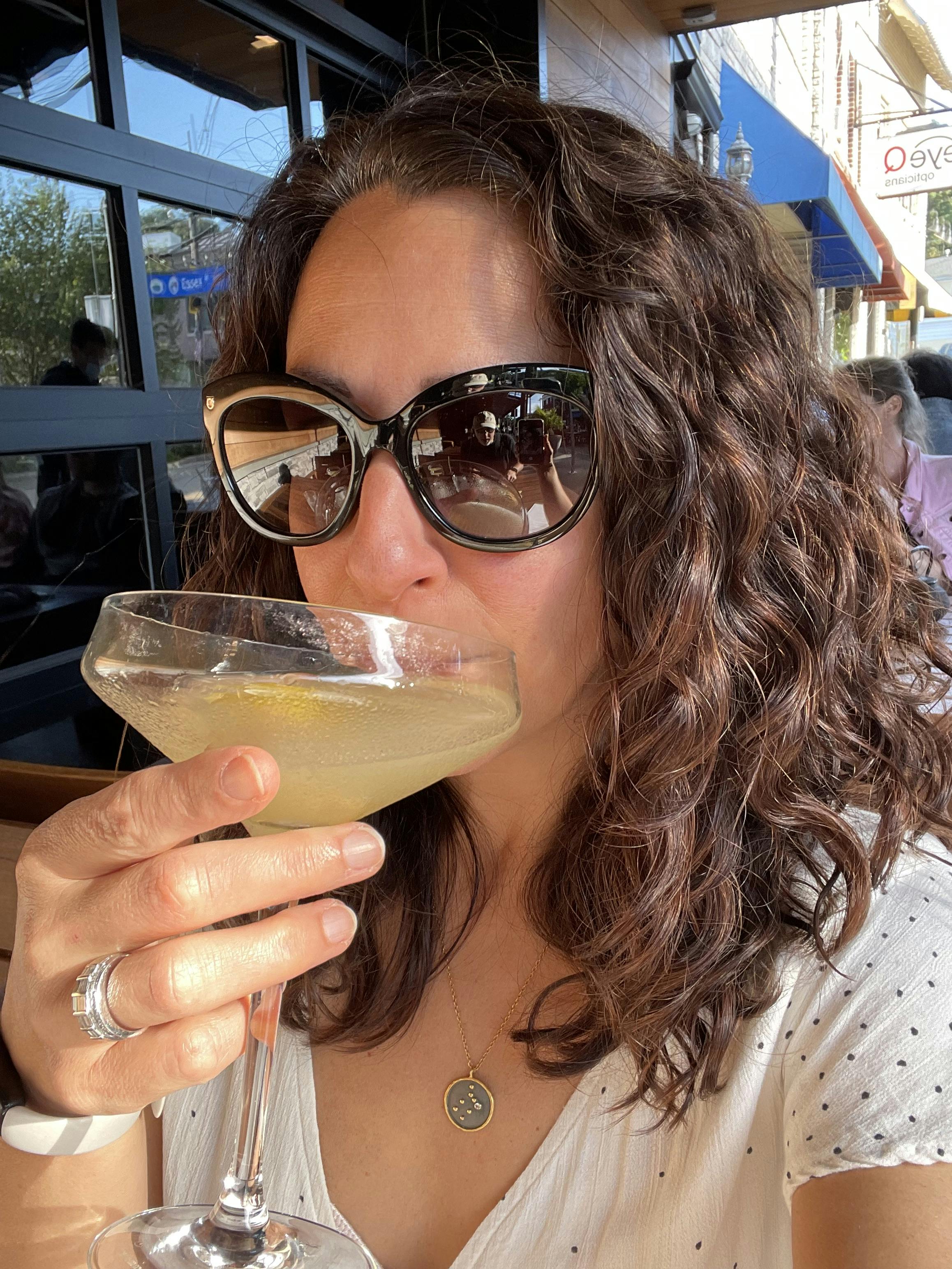 Melanie Mannarino sipping a cocktail